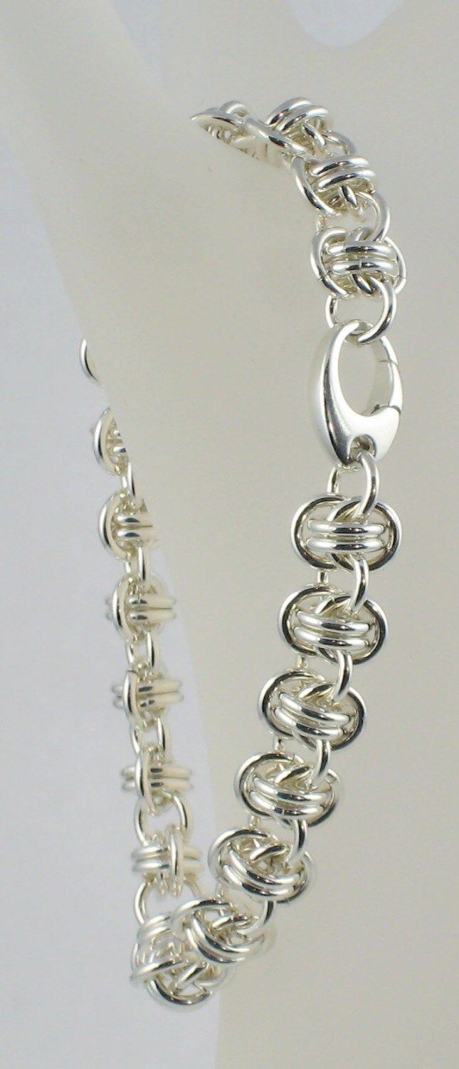 "This bracelet is delicate, but still makes a statement. Perfect alone or in combination with other bracelets for a stacked look.  - Links: .925 solid sterling silver - Clasp: .925 sterling silver oval push clasp (Can be changed out to a ring and bar toggle if you prefer; please Convo me and I'll provide you with a custom quote if the price changes.) - 3/8\" wide - Standard is 7-1/4\" long or length specified (see ORDERING NOTES below) - If you need the bracelet longer, please CONTACT me and I'l Metal Chainmail Bracelet, Chain Maille Jewelry Weave Got Maille, Silver Chainmail Chain Link Bracelets, Adjustable Chainmail Chain Bracelet, Captured Bead Chainmaille, Jump Ring Jewelry, Chainmaille Bracelet, Stylish Earring, Organza Gift Bags