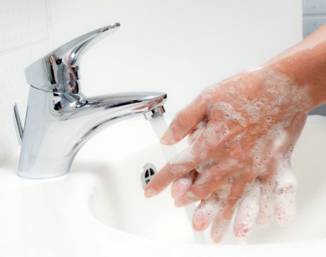 a person washing their hands with soapy water from a faucet on a sink