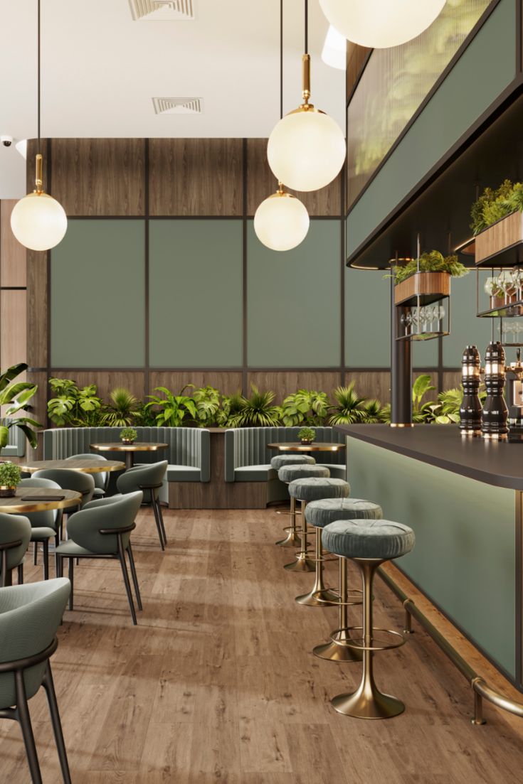 a bar space with wooden and green walls and the bar table Restaurant Colour Combination, Sage Green Restaurant Interior, Dark Green Restaurant, Sage Green Cafe Aesthetic, Restaurant Lights, Sage Green Restaurant, Bamboo Cafe, Earthy Restaurant Design, Green Cafe Design