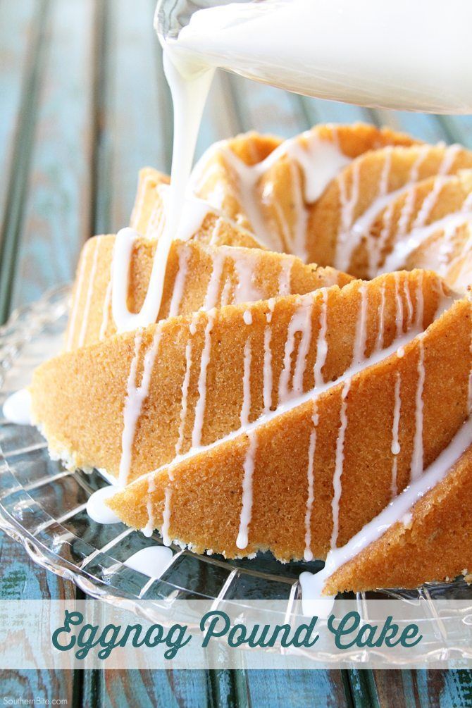 an eggnog pound cake with white icing on a glass platter, being drizzled with glaze