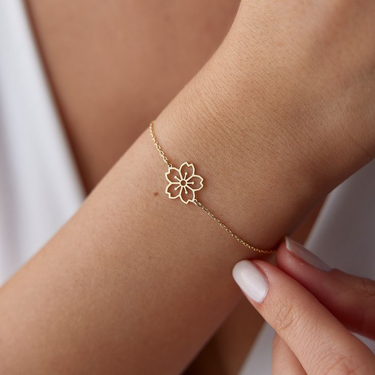 This delicate and elegant bracelet is made with high-quality 14k gold and features a real gold cherry blossom charm. The bracelet is also adorned with a dainty sakura flower charm and a birth flower charm, making it a unique and personal gift for any occasion. This bracelet makes a perfect gift for any occasion, from a birthday to a graduation to a wedding. It is a unique and personal gift that the recipient will cherish for years to come. D E T A İ L S * Material: 14k Solid Gold (Real Solid Gol Delicate Rose Gold Plated Gold Bracelet, Delicate Rose Gold Plated Bracelet, Everyday Yellow Gold Flower-shaped Jewelry, Yellow Gold Flower Jewelry For Everyday, Everyday Yellow Gold Flower Jewelry, Elegant Rose Gold Bracelets With Flower Charm, Elegant Rose Gold Bracelet With Flower Charm, Delicate Yellow Gold Flower Bracelet, Dainty Yellow Gold Bracelet With Flower Charm