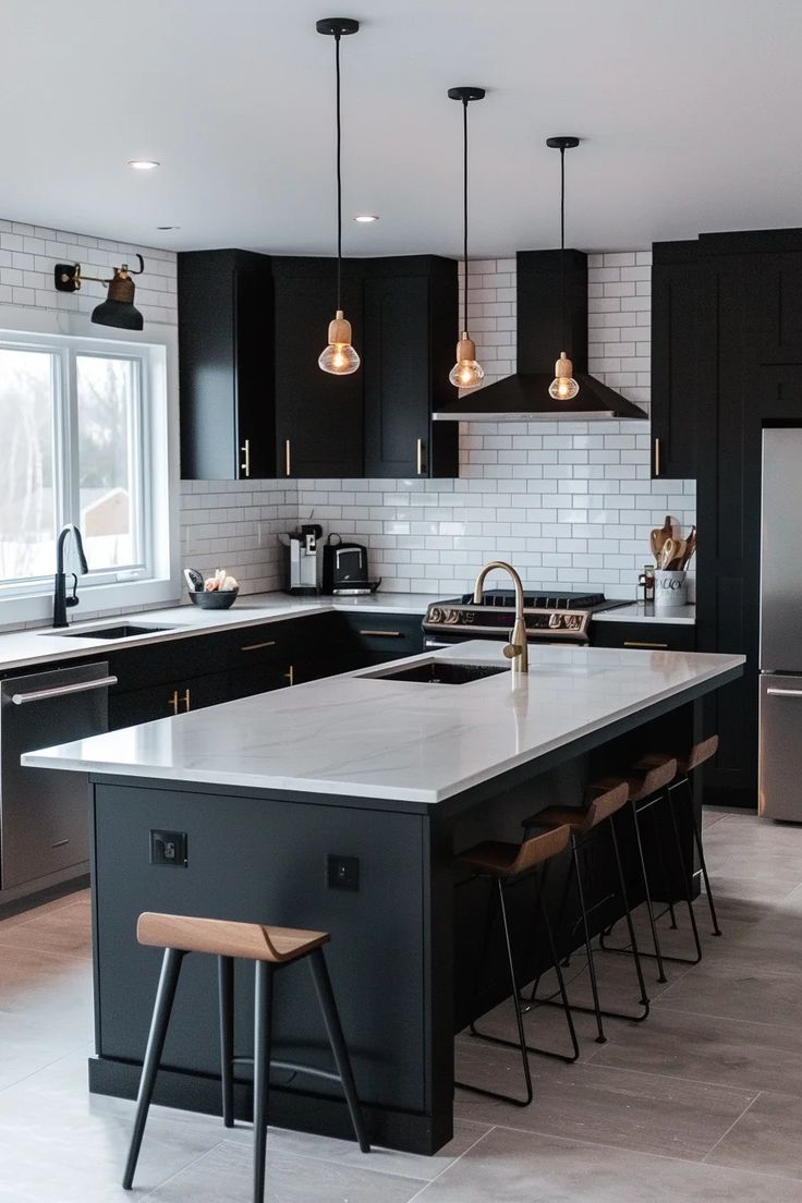 a kitchen with black cabinets and an island