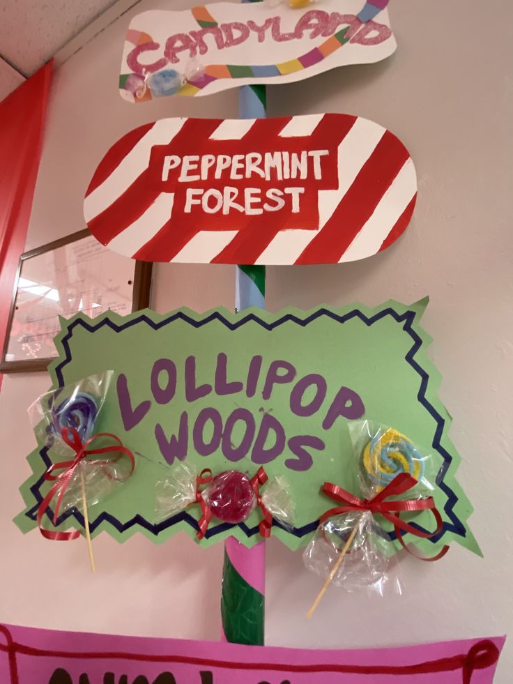 some candy lollipops are on top of a sign that says peppermint forest