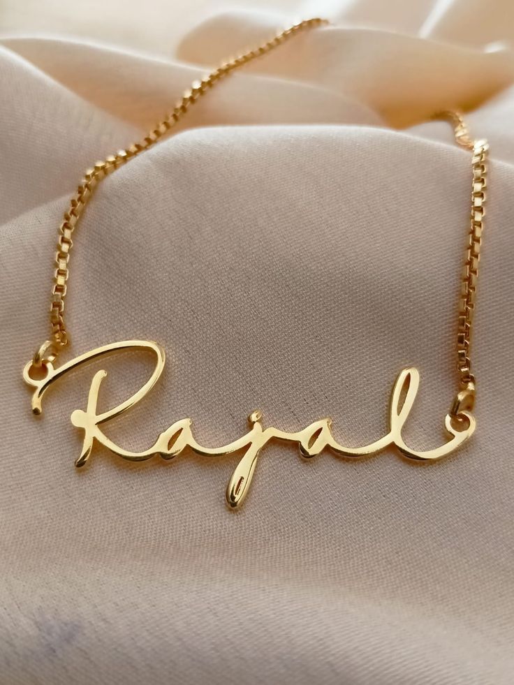 Name necklace gifts are one of the best ways to show your loved ones how much you value them. Combining beautiful jewelry with a loved ones name is never a failing idea. Our name necklaces are fully customizable from the font to the pendants, they are personalized to your liking. Order one of our 18k gold plated necklaces to show your appreciation to your loved ones. 18k Solid gold plated name necklace is perfect gift for birthday. Hello, every woman loves personalized gifts. In fact, we all lov Customized Nameplate Necklaces For Anniversary, Yellow Gold Name Necklace For Anniversary Gift, Rose Gold Name Necklace For Anniversary, Personalized Gold Necklace For Anniversary, Custom Yellow Gold Names Necklace For Gifts, Personalized Gold Necklace For Anniversary Gift, Customized Nameplate Jewelry For Anniversary Gift, Customizable Yellow Gold Name Necklace For Anniversary, Custom Pendant Necklace For Personalized Gifts