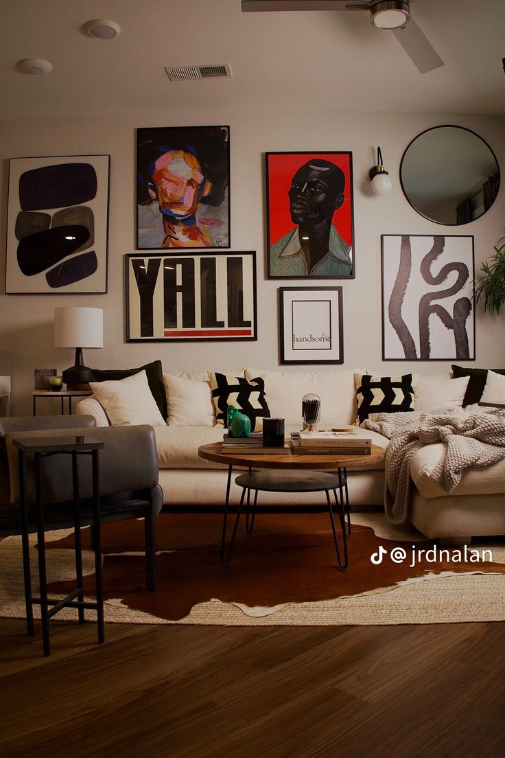 a living room filled with furniture and pictures on the wall above it's coffee table