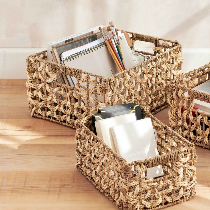 three wicker baskets with books and magazines in them