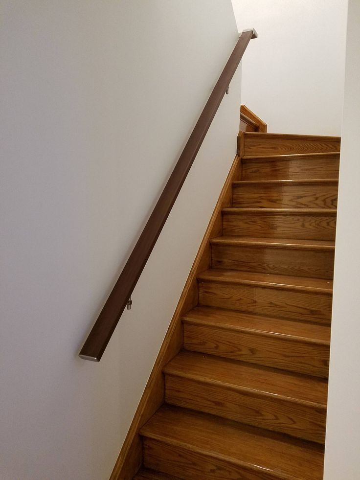 the stairs are made of wood and have metal handrails