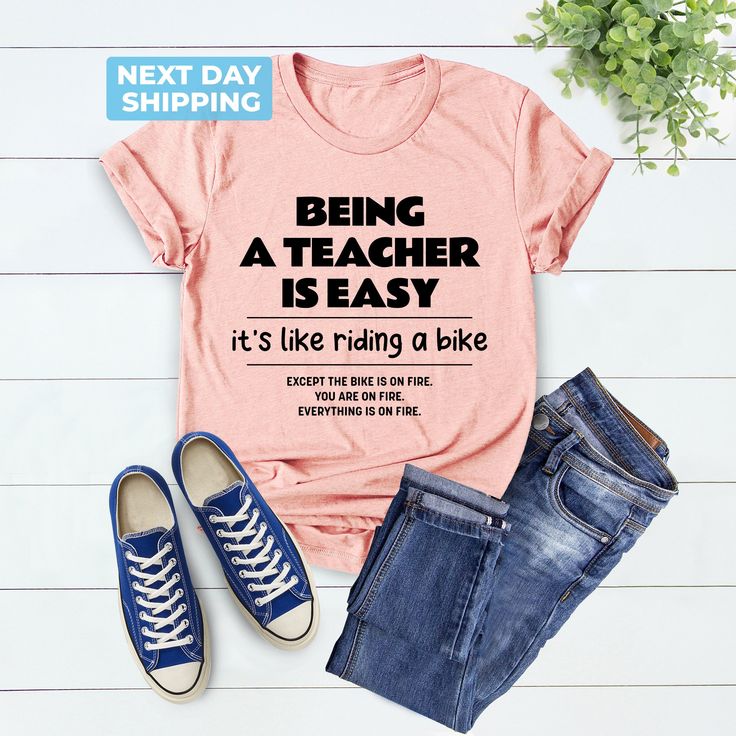 Cute Teacher Shirt, Being A Teacher Is Easy Back To School Like Riding A Bike, School Shirt, Funny Teacher Shirt, Unique Gift, Teacher Gift Hi! Welcome to the LaTeeApparel!  It's great to see you here! Our shirts are clean, high quality and soft. It is prepared quickly by our store! Enjoy your shopping! It is a pleasure for us to help you with your questions and you can reach us at any time. F I T  ∙ S I Z I N G  -->Women's sizes are narrower than the waist -->Sleeves are rolled up in some produ Short Sleeve Graphic Print Cycling Tops, Graphic Print Short Sleeve Cycling Top, Graphic Print Short Sleeve Tops For Cycling, Casual Cotton T-shirt For Cycling, Preschool Teacher Shirts, Being A Teacher, Riding A Bike, Teacher Things, Funny Teacher