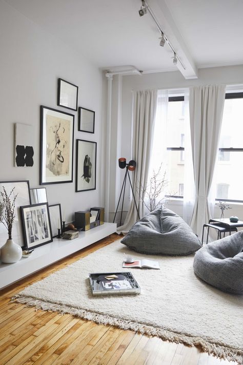 a living room filled with furniture and pictures on the wall