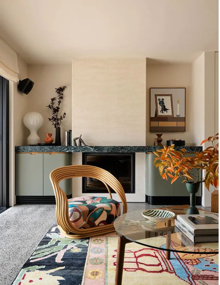 a living room filled with furniture and a fire place next to a sliding glass door