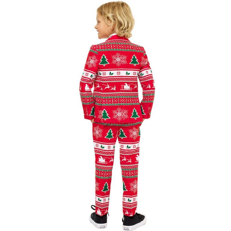 a little boy wearing a red christmas suit with trees and snowflakes on it