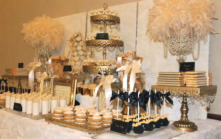 a table topped with lots of desserts and cupcakes