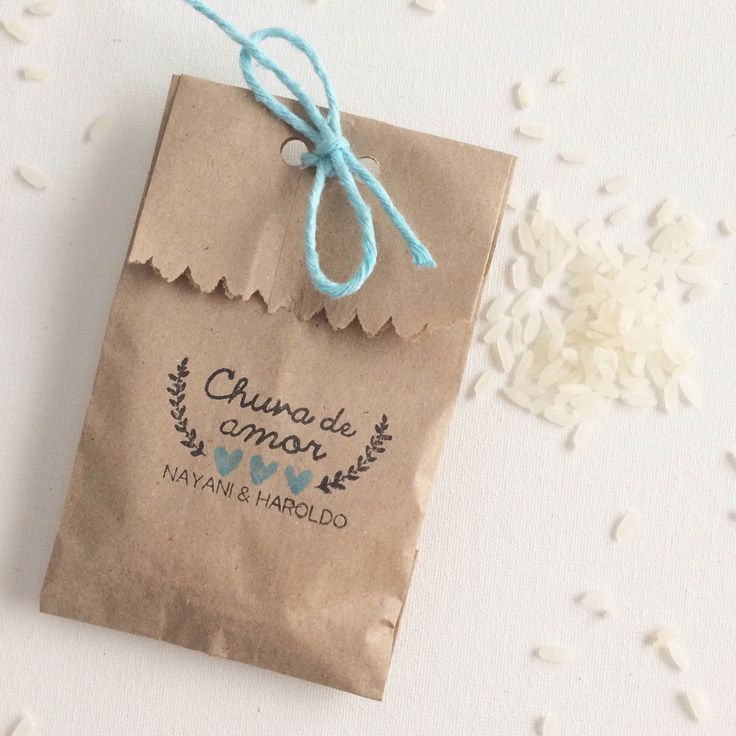 a brown paper bag sitting on top of a white table next to rice flakes