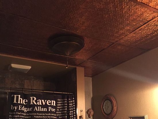 there is a sign that says the raven by edgar allian poe on the wall