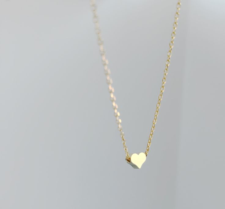 "Dainty necklace, gold Heart necklace, gold necklace, Dainty jewelry, gift for her, simple necklace, gift for women, dainty necklace, birthday gift for her Simple and dainty gold heart necklace. D E T A I L S: *5mm tiny gold plated heart *18\" gold plated chain *Lobster clasp closure This style is also available in rose gold and silver in our shop! SHIPPING: *Free domestic shipping on all orders PACKAGING: *All pieces come beautifully packaged, perfect for gift giving. Find more to ❤️ here: http Simple Necklace With Heart Charm As A Gift, Simple Gold Charm Necklace For Valentine's Day, Tiny Dainty Heart Necklace For Gift, Dainty Tiny Heart Necklace For Gifts, Dainty Small Heart Necklace For Gift, Dainty Gold Plated Necklace For Valentine's Day, Tiny Dainty Heart Necklace Gift, Simple Heart Pendant Charm Necklace For Gift, Simple Heart Pendant Charm Necklace As Gift