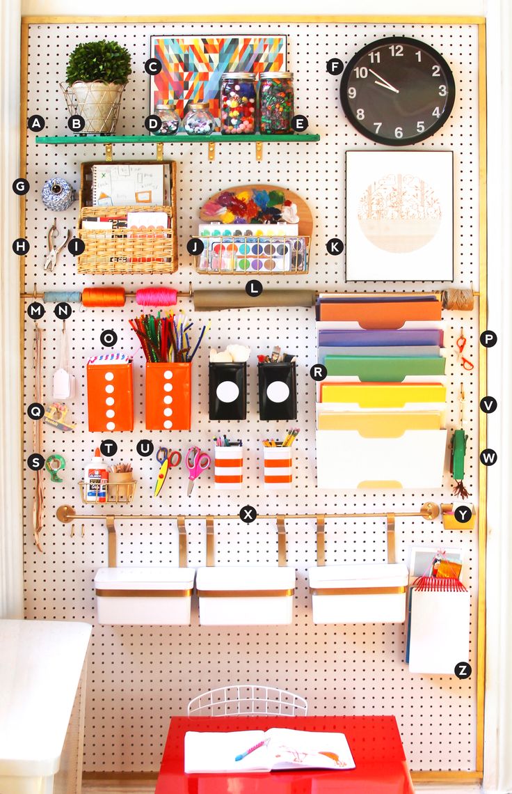 a pegboard with lots of different things on it and a clock mounted to the wall