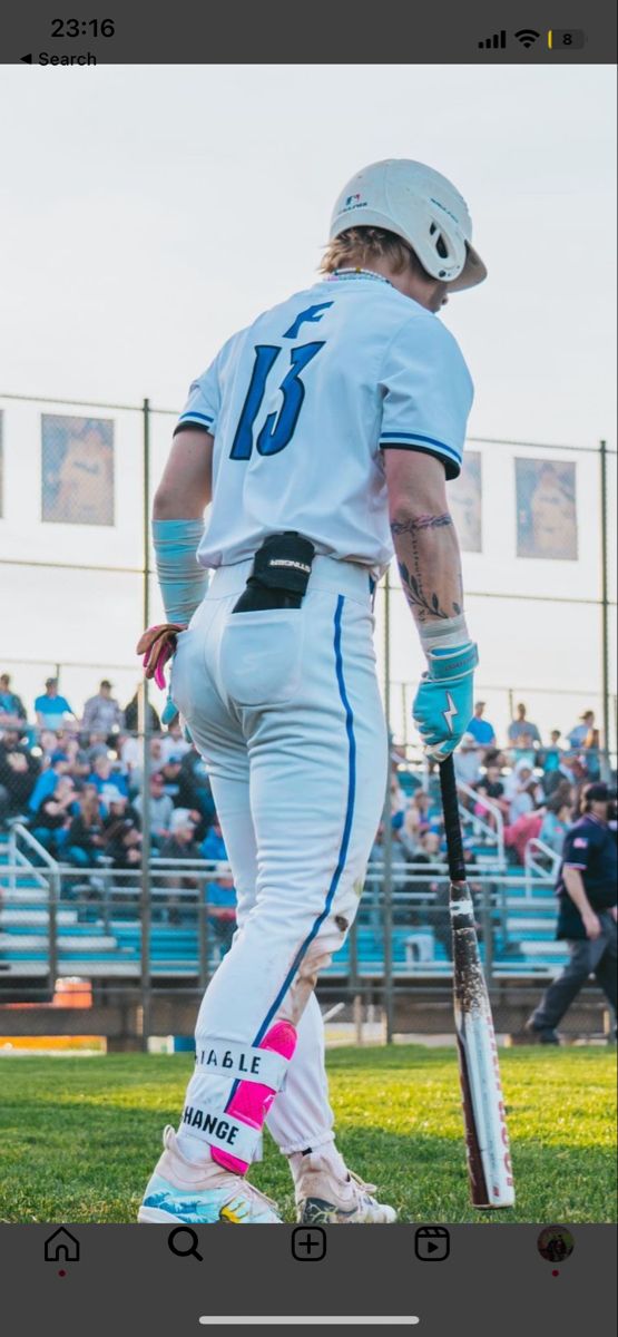 a baseball player holding a bat on top of a field in front of a crowd