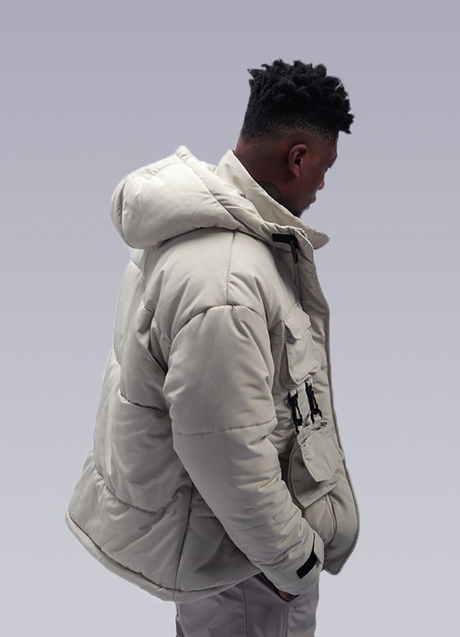 Experience urban sophistication with our streetwear puffer jacket: your winter essential. Discover the ultimate winter jacket for the fashion-forward urban dweller: the men's Streetwear Puffer Jacket. Picture yourself striding confidently through the city streets, without fear of what the day may bring, confident in your style. This padded jacket is designed with streetwear in mind, perfect for those who want to make a statement while staying warm and comfortable. The Men's Streetwear Puffer Jacket comes in two elegant and versatile colors: beige and black. The tactical straps that connect the two pockets add a touch of sophistication to the jacket, inspired by military jackets. The straps and buckle at the heart complete the atmosphere and give you an even more intimidating look. This jac Streetwear Puffer Jacket, Apocalyptic Clothing, Military Jackets, Techwear Pants, Men's Streetwear, Chest Rig, Beige And Black, Winter Essentials, Patchwork Designs