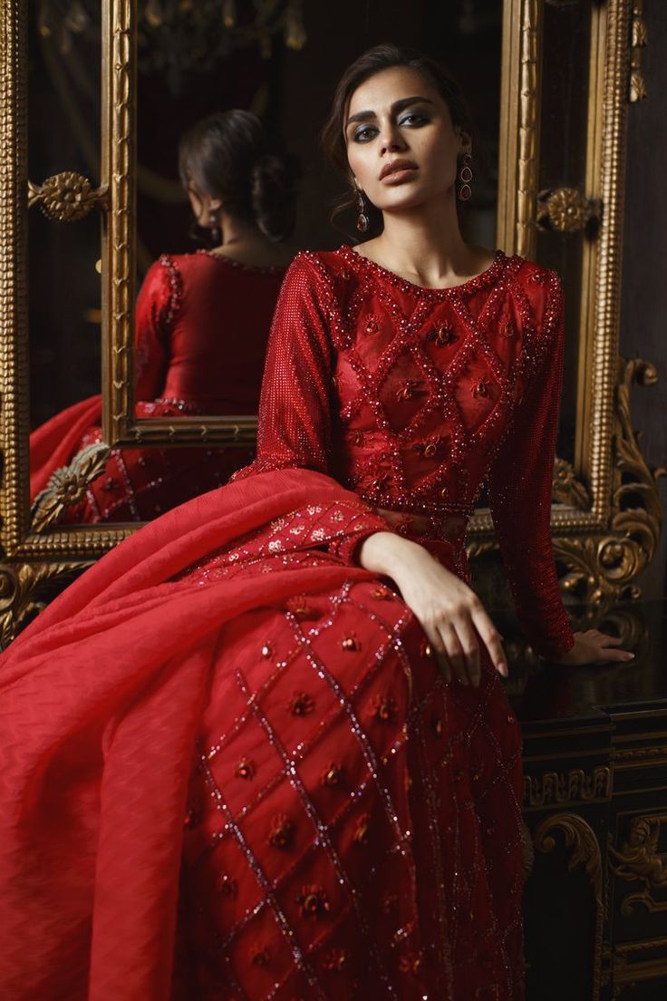 Red Lehenga Gown and Dupatta Pakistani Bridal Dress is an epitome of tradition and royalty and it simply wins everyone's hearts at the very first glance. Hand-crafted embellishments and premium fabric of this alluring Red Bridal Dress Pakistani make it your foremost priority. Gown: The hand-embellished Pakistani Gown in Brocade and mesh fabric is a stunning attire to pair with a Lehenga. The beautiful embroidery work and shimmering details on this stunning red gown make it an epitome of beauty. Semi-stitched Floor-length Gown For Traditional Ceremonies, Red Embellished Organza Sets, Elegant Red Sharara With Traditional Drape, Traditional Floor-length Gown For Reception, Organza Gown For Festive Traditional Ceremonies, Traditional Floor-length Hand Embellished Salwar Kameez, Red Organza Floor-length Sharara, Traditional Embellished Maxi Lehenga, Organza Gown For Traditional Ceremonies And Festive Events