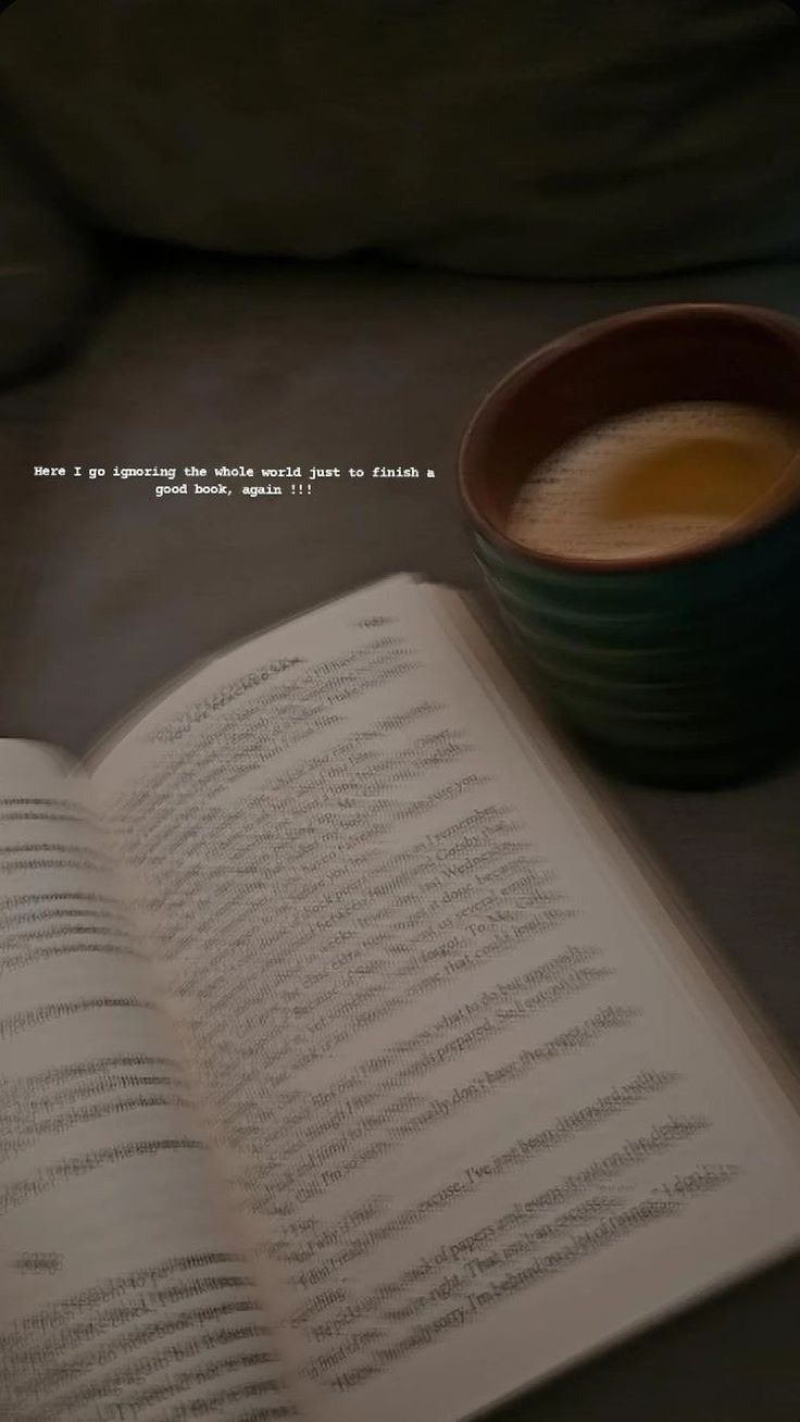 an open book next to a cup of coffee