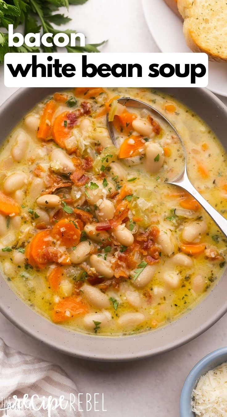 a bowl of white bean soup with bread and parmesan cheese on the side