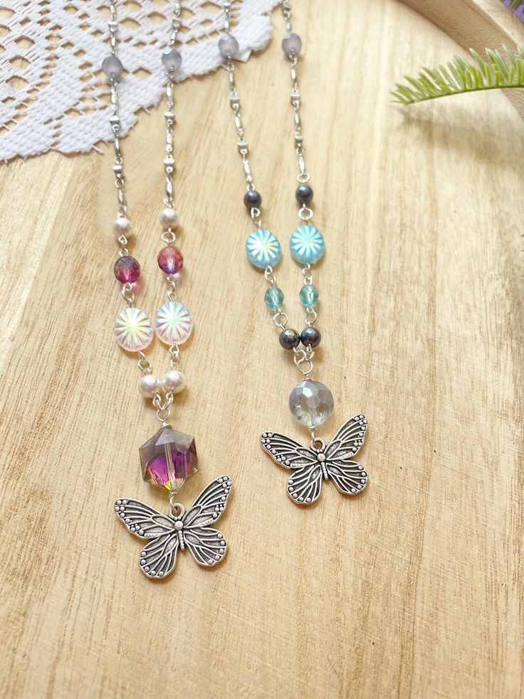 "Pearls and Sparkles! These gorgeous necklaces feature shell pearls in your choice of color, white or grey, and feature my favorite fabulous silver metal butterfly pendants. Perfect for that special butterfly lover in your life!  Handmade beaded chain made with non tarnish silver wire. White pearls are accented with pink crystals, Czech glass, and Firepolish beads. Grey pearls are accented with blue crystals, Czech glass, and Firepolish beads. Added high quality link chain in bright silver for l Silver Dangle Pearl Beaded Necklaces, Silver Pearl Beaded Necklaces With Dangle Shape, Silver Pearl Beaded Dangle Necklaces, Adjustable Silver Charm Necklace With Beaded Chain, Adjustable Silver Beaded Chain Charm Necklace, Silver Necklaces With Colorful Beads For Jewelry Making, Silver Beaded Charm Necklaces For Gifts, Silver Pearl Jewelry With Colorful Beads, Silver Beaded Butterfly Necklace For Gift