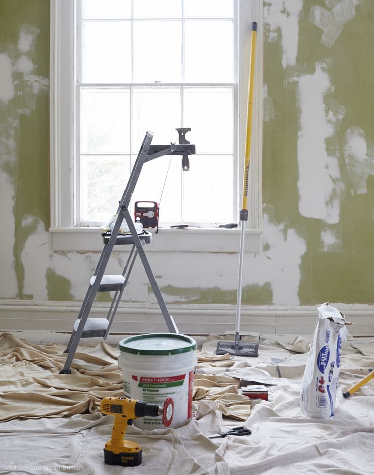 a bucket and some tools sitting on top of a table in front of a window