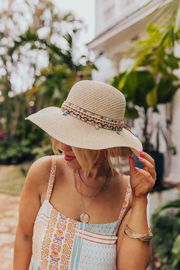 - Live your best beach life with this trendy raffia hat! - Woven material - A woven band featuring browns, peach, and turquoise and a tie detail - Dangling seashell and starfish charms - Hat Dimensions: - Length-16 Inches - Width- 15.5 Inches - Height-4 Inches - Cranial Circumference- 22 Inches - Brim Width- 4 Inches Beachy Cream Sun Hat For Vacation, Beige Beachy Straw Hat For Beach, Lightweight Bohemian Straw Hat For Beach, Beachy Straw Hat For Travel, Beachy Cream Hat For Vacation, Bohemian Beige Straw Hat For Travel, Cream Beachy Hat For Vacation, Bohemian Cream Sun Hat For Vacation, Bohemian Adjustable Lightweight Straw Hat