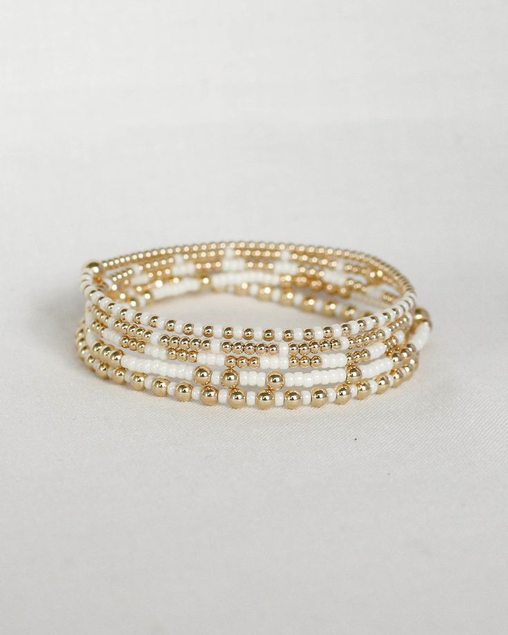 ‣ This listing is for a single bracelet, or stack of 5. ‣Olivia + Bella bracelets feature: * 2mm Seed Beads * 3mm 14k Gold Filled Beads * 1-5mm 14k Gold Filled Bead ‣Madi + Chloe + Luna bracelets feature: * 2mm Seed Beads * 2mm 14k Gold Filled Beads * 1-4mm 14k Gold Filled Bead Julisa Bracelets Feature:  ‣ Tight/Sturdy elastic, pre-stretched to prevent bracelet from stretching out ‣ Sizing according to wrist size ‣Sizing Tips:  Please measure your wrist for the best fit!  *Using a soft tape measure/string, measure around your wrist, above the wrist bone *Add length according to your desired fit:       * 0" - fitted, snug      * .25" - slight movement      * .5" -  relaxed      * .75"- loose      * 1" - extra loose *Please message us if you need any help with sizing!  ------- ‣Each bracelet Elegant Heishi Bead Bracelets With Tiny Beads, White Stackable Heishi Beads Jewelry, Everyday White Beaded Wrap Bracelet, White Round Beads Wrap Bracelet For Everyday, White Round Beads Wrap Bracelet For Daily Wear, White Beaded Bracelets In 14k Gold Filled, White Wrap Bracelet With Round Beads For Everyday, Adjustable White Beaded Bracelets In 14k Gold Filled, White Rondelle Jewelry With Tiny Beads