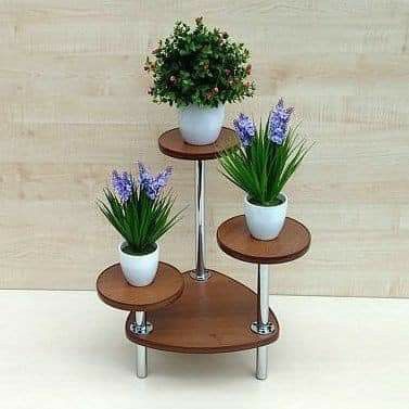 three tiered plant stand with potted plants on each shelf and flowers in the middle