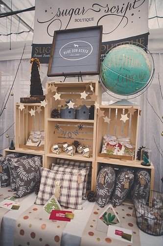 a display in a store filled with lots of pillows and other items on top of a table