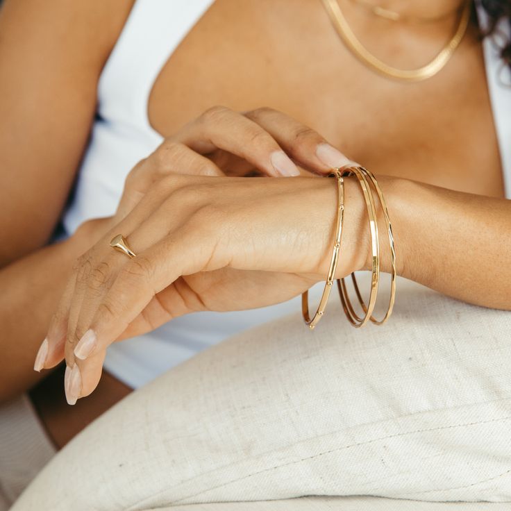 The Demi Bangle Bracelet is a chic, minimalistic accessory that adds a subtle yet sophisticated touch of glamour to your look. Crafted in a lightweight gold bangle, it'll elevate any ensemble with effortless elegance. So why not give your look an iconic finish? Get your must-have accessory now. Available in 14k gold plated brass Width: 2mm Interior diameter measures 2 1/2" SKU: BYB1180 Elegant Everyday Gold-tone Bangle, Chic Everyday Bangle With Bracelet Strap, Minimalist Yellow Gold Metal Bangle, Chic Gold Plated Bangle Bracelet, Modern Gold-tone Bangle Bracelets, Chic Gold-tone Metal Bangle, Chic Gold Metal Bangle Bracelet, Minimalist Gold-tone Bangle Bracelets, Minimalist Gold-tone Bangle Bracelet