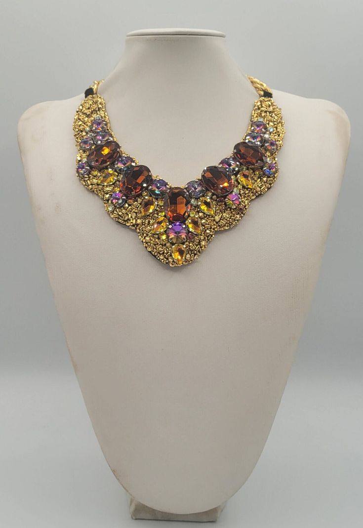 Each piece of our statement necklaces is handmade and one of a kind made in Italy. Our creations is made of high quality materials such as crystals and rhinestones. Each embroidered material is carefully hand sewn. Very glamorous and stylish. Perfect gift to someone you like. Materials Strass stone and Rhinestone in Rainbow, Cooper and Brown color in different dimension.  Black satin fabric backing. Aluminium chain with lobster closure. Measurements Weight approximate 200 grams. Chain lenght 25 cm - 9.84 in Circumference approximate 63 cm - 24.80 in Feel free to contact us if you have any question. Thank you so much for looking at our shop and our articles each of them, single piece. Luxury Gold Beaded Necklace For Party, Costume Jewelry Jeweled Choker Necklace, Luxury Jeweled Choker Necklace, Costume Jewelry Rhinestone Pendant Necklace For Party, Costume Jewelry Necklace With Sparkling Stones For Party, Luxury Jeweled Bridal Necklace Gift, Handmade Choker Necklace For Evening, Elegant Multicolor Evening Necklaces, Bridal Pendant Necklace With 17 Jewels For Party