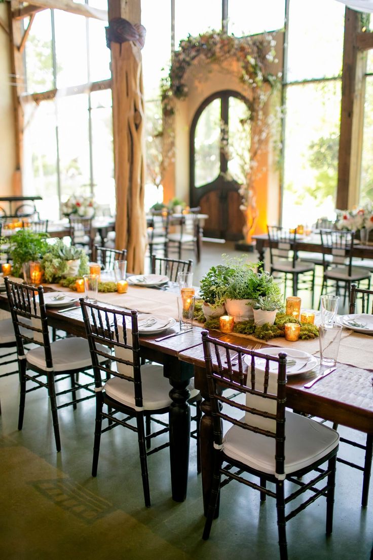 the tables are set with candles and centerpieces