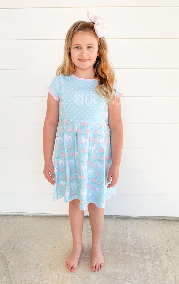 "\"He saw Jesus passing by, and said, \"Look! This is the Lamb of God!\" John 1:36 FBV This short sleeve dress is sure to be a spring favorite. Sweet ruffles at the sleeves and delicate pink trim with pink buttons on the back. This style is also great for monograming. What better way to discuss John 1:36 and Jesus than with a lamb print. Easter is a wonderful time to talk about the Lamb of God, Christ, with your child. She will love looking at the sweet lamb on this dress. We placed God's word i Summer Short Sleeve Dress For Sleepover, Summer Sleepover Dress With Short Sleeves, Cute Short Sleeve Dress With Ruffle Hem, Playful Ruffled Short Sleeve Dress, Playful Short Sleeve Dress With Ruffles, Casual Short Sleeve Dress With Flutter Sleeves For Spring, Cotton Short Sleeve Dress For Sleepover, Cute Spring Dress For Sleepover, Cute Spring Sleepover Dress