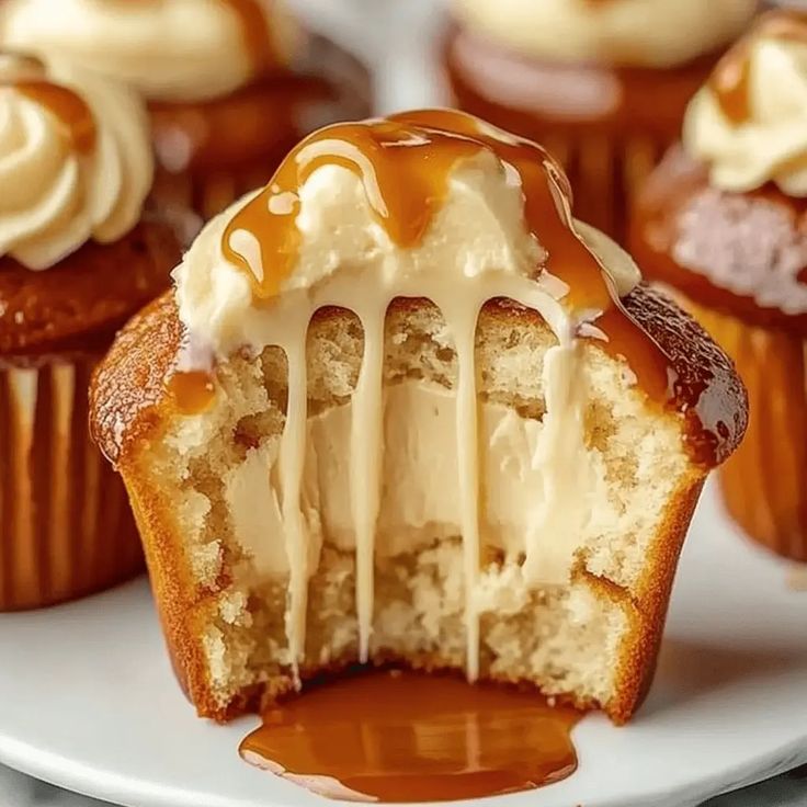 cupcakes with icing and caramel drizzled on the top