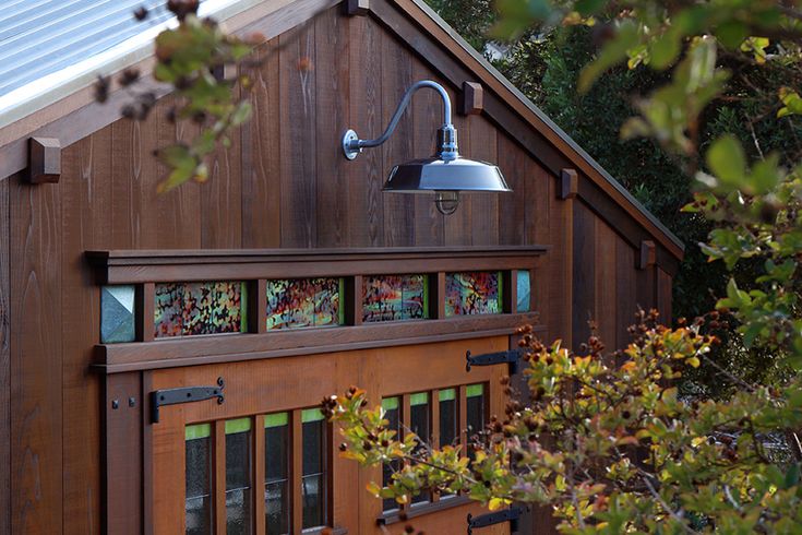 a wooden building with a light on top of it