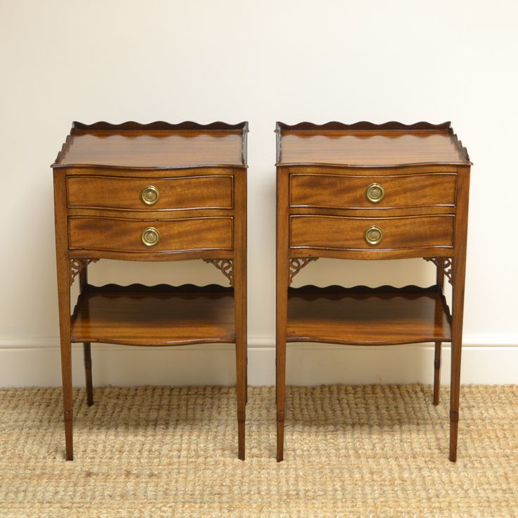 two wooden nightstands sitting next to each other on top of a carpeted floor