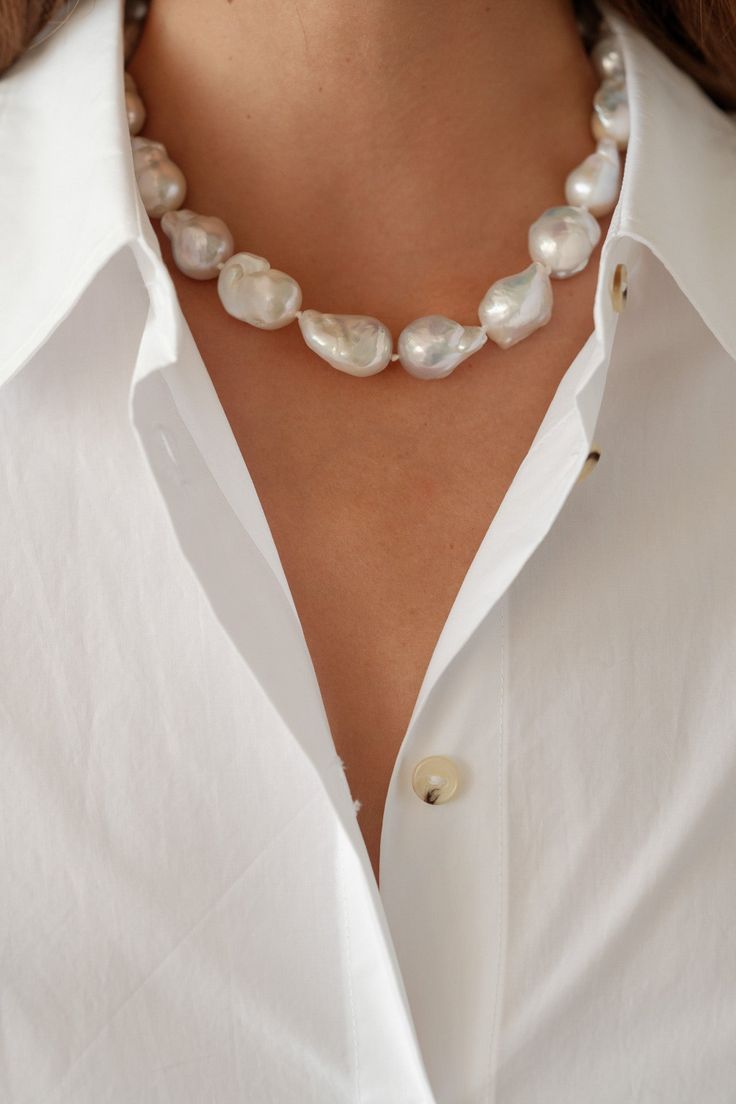 This baroque pearl choker elevates the everyday. A casual statement piece that makes for great layering––you will never want to take it off! Each pearl is unique, and is subject to its own perfect imperfections. Pearl measures approximately 1/2" and is strewn on invisible 15" chain with invisible screw clasp. Made in the U.S.A. * This product is crafted with natural pearls, and variations make each piece unique. Item ships within 1 to 2 weeks and is excluded from ALL discounts Repurposed Pearl Jewelry, Thick Pearl Necklace, Clothes With Pearls, Beach Pearl Necklace, Pearl Styling, Pearl Jewellry, Pearl Necklace Outfit, Statement Pearl Necklace, White Pearl Choker