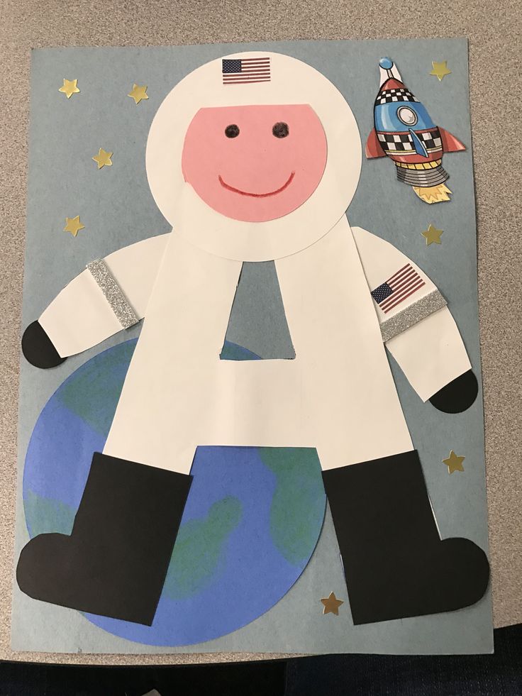 a paper cut out of an astronaut on the ground