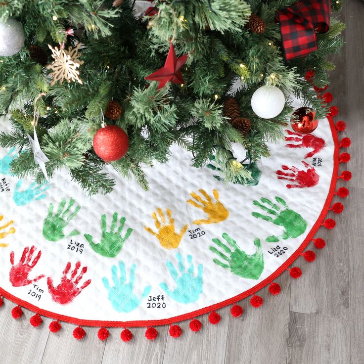 a christmas tree skirt with handprints on it