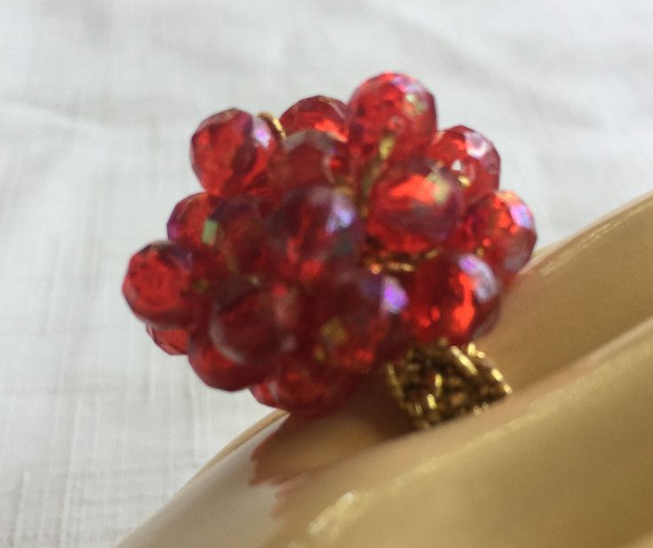 "Red 60s or 70s Big Ring with a band made of gold Stretchy fabric, so it's one size fits all. The ring is basically a 1\" mound of Ruby Red Faceted plastic stones, woven into a shiny red mound. Also, please take a look at my storefront at: https://www.etsy.com/shop/FabFinds42?ref=seller-platform-mcnav I have a wide selection of one-of-a-kind items, from clothing and toys to home decor and gift items, and I add new things almost every day." Round Red Ruby Party Ring, Party Ruby Ring With Round Shape, Vintage Adjustable Red Ruby Ring, Adjustable Vintage Ruby Ring, Handmade Adjustable Red Ruby Ring, Hippie Ring, Stretchy Rings, Shiny Rings, Red Costume