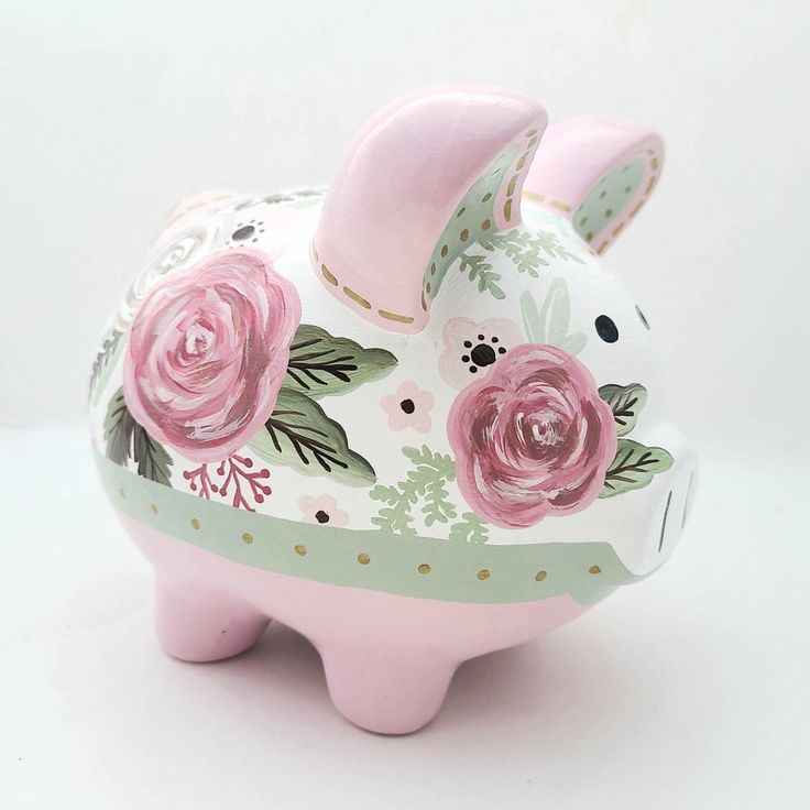 a pink pig with flowers painted on it