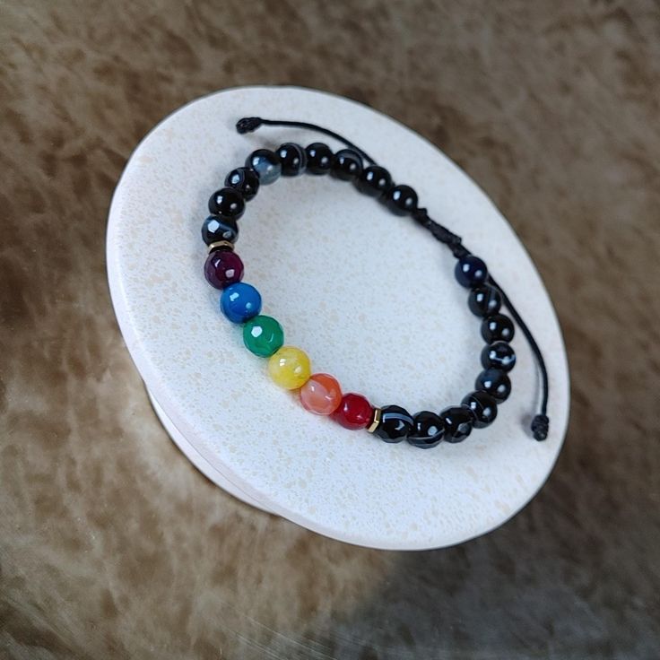 LGBTQ Rainbow Gemstone Bracelet - Discreet Pride Bracelet, Adjustable Cord Jewelry, Handmade Gift for Women's & Men's LGBTQ Rainbow Bracelet, a stunning Pride Gemstone Bracelet featuring the iconic Gay Flag colors. This Adjustable String Bracelet, handmade with care, makes for a perfect Pride Month Gift or a thoughtful Christmas Gift for Her and Him. Details: - Minimalist, elegant, and casual design. - Crafted with 6mm rainbow color agate and black agate stones, hematite beads. - Adjustable fit Rainbow Crystal Bracelet With Round Beads For Gift, Adjustable Multicolor Pearl Bracelet With Gemstone Beads, Multicolor Adjustable Pearl Bracelet With 8mm Beads, Adjustable Multicolor Pearl Bracelet With 8mm Beads, Adjustable Rainbow Bangle, Rainbow Hand-strung Jewelry For Friendship, Adjustable Rainbow Hand-strung Jewelry, Rainbow Bracelet Jewelry For Healing, Adjustable Rainbow Bracelets With 8mm Beads