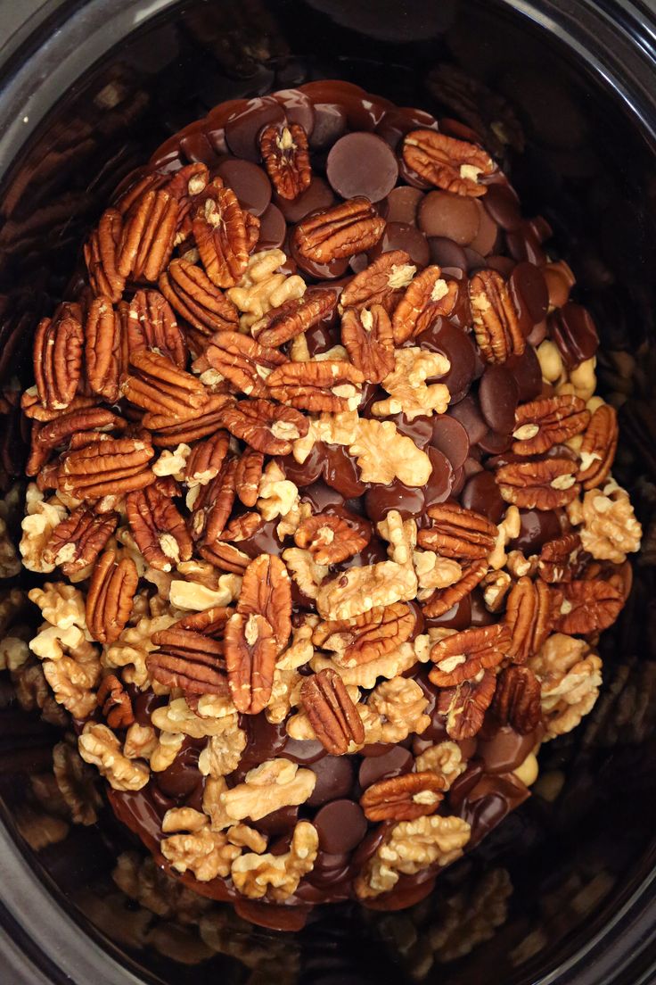 a crock pot filled with nuts and chocolate