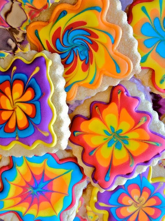 colorful decorated cookies are displayed on a table