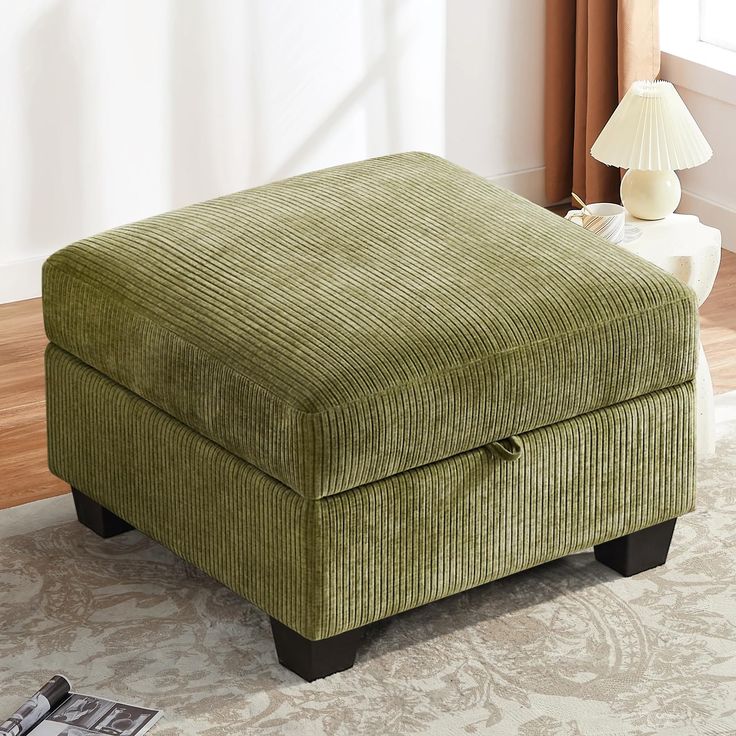 a green ottoman sitting on top of a rug