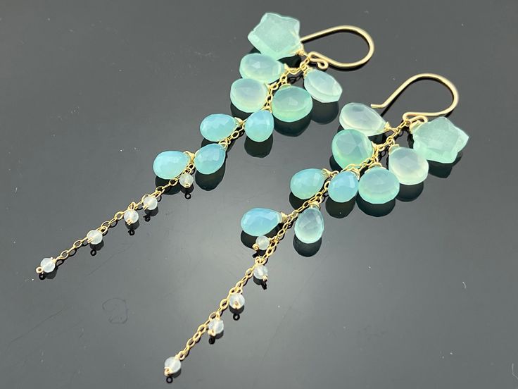 Faceted Aqua Blue Chalcedony Earrings are 98 mm (3.85 inches) long. Swan-style earwires. Weight: 55.5 Ct All components are 14K Gold Filled. Earrings come with a free gift box. IMPORTANT! ORDERS ARE NO LONGER SHIPPED TO GERMANYPlease read the description carefully, and check all the measurements before placing an order so the item received will not be bigger, smaller, shorter, or longer than expected. Please let me know if you have any questions. Aqua Earrings, Chalcedony Earrings, Asymmetrical Earrings, Wire Jewelry Designs, Jeweled Earrings, Ocean Jewelry, Jewelry Accessories Ideas, Earrings Inspiration, Jewelry Lookbook