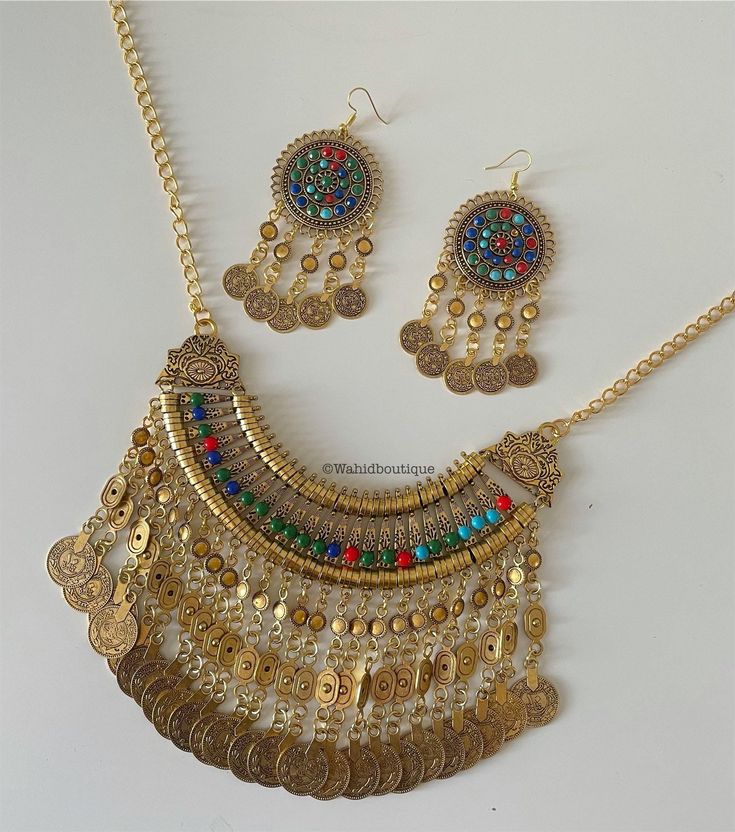 Afghan Modern gold jewellery set, Afghan jewellery  Set includes: -1 pair of earrings  -1 necklace  Message for any enquiries Our Aim as a business is to connect Afghan women with their roots and to make anyone that purchases our jewellery feel powerful and beautiful as each and everyone of our items is handcrafted with care and love. Afghan Gold Jewellery, Gold Plated Round Jewelry Sets For Festivals, Gold Plated Jewelry Sets For Festivals, Gold Jewelry Sets With Matching Earrings For Celebration, Gold Dangle Jewelry Sets For Festive Occasions, Traditional Gold Dangle Jewelry Sets, Gold Dangle Jewelry Sets For Celebration, Festive Gold Dangle Jewelry Sets, Traditional Metal Jewelry Sets With Jewels