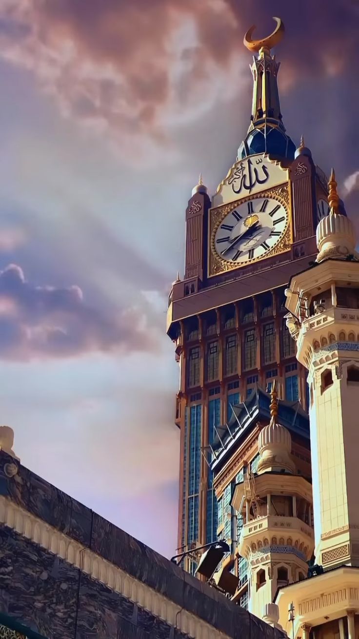 a large clock tower on top of a building with clouds in the sky behind it